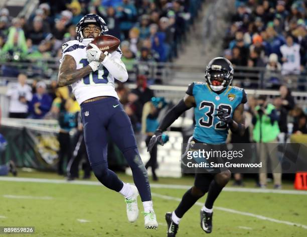 Paul Richardson of the Seattle Seahawks makes a catch in front of Tashaun Gipson of the Jacksonville Jaguars during the second half of their game at...