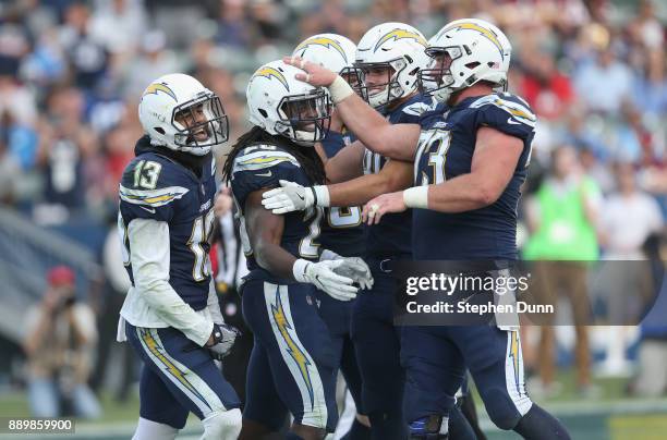 Running back Melvin Gordon of the Los Angeles Chargers celebrates with Spencer Pulley, Hunter Henry, and Keenan Allen after scoring on a one yard...