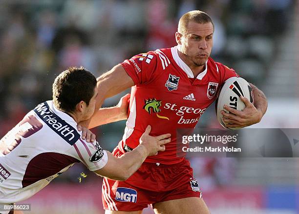 Matt Cooper of the Dragons is tackled during the round 18 NRL match between the St George Illawarra Dragons and the Manly Warringah Sea Eagles at WIN...