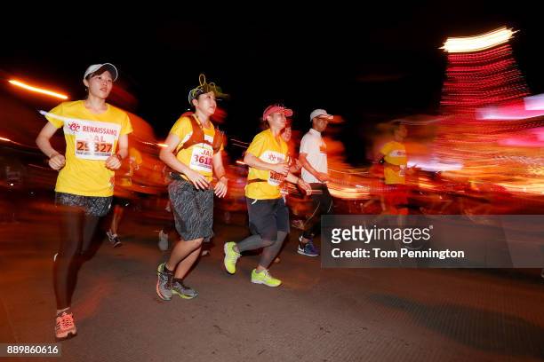 Participants run past a holiday illumination during the Honolulu Marathon 2017 on December 10, 2017 in Honolulu, Hawaii.