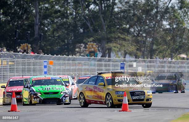 The safety car holds up the field during race 12 for round six of the V8 Supercar Championship Series at Reid Park on July 12, 2009 in Townsville,...