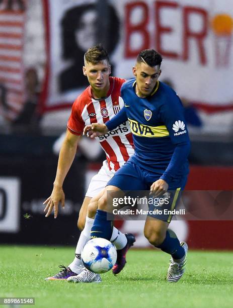 Cristian Pavon of Boca Juniors fights for ball with Gaston Campi of Estudiantes during a match between Estudiantes and Boca Juniors as part of the...