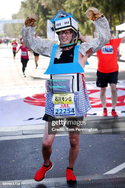 Participants celebrate after crossing the finish line during the Honolulu Marathon 2017 on December 10, 2017 in Honolulu, Hawaii.