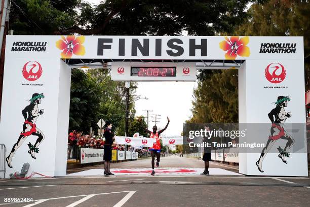 Dennis Kimetto of Kenya crosses the finish line to win the men's marathon during the Honolulu Marathon 2017 on December 10, 2017 in Honolulu, Hawaii.