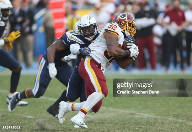 Running back Samaje Perine of the Washington Redskins carries the ball against safety Adrian Phillips of the Los Angeles Chargers in the third...