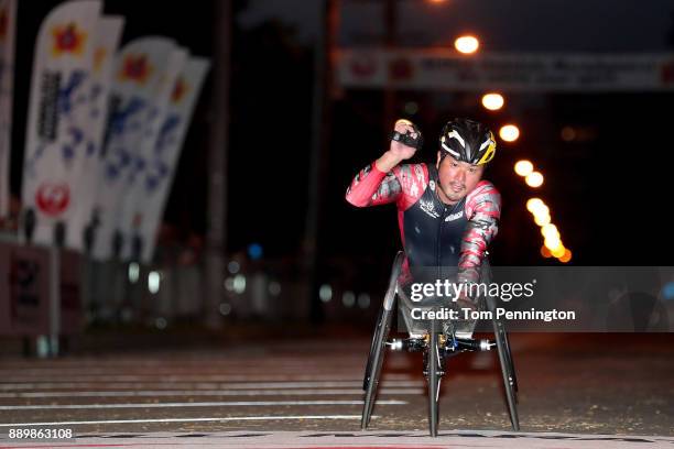 Wheelchair participant Masazumi Soejima crosses the finish line to win the Men's Wheelchair division during the Honolulu Marathon 2017 on December...