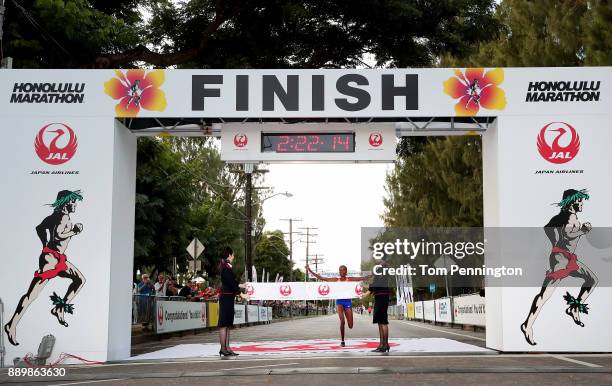 Bridgid Kosei of Kenya crosses the finish line to win the Women's division of the Honolulu Marathon 2017 on December 10, 2017 in Honolulu, Hawaii.