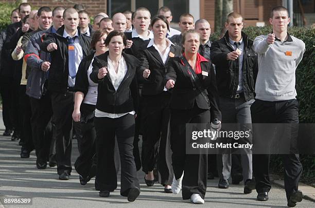 Royal Navy recruits, still in their civilian clothes, are marched to the clothing store as they arrive at the training establishment HMS Raleigh for...