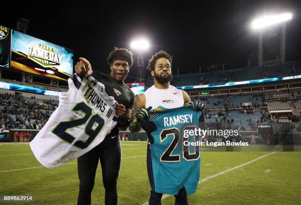 Jalen Ramsey of the Jacksonville Jaguars and Earl Thomas of the Seattle Seahawks exchange jerseys on the field after the Jaguars defeated the...