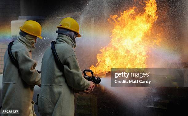 Royal Navy recruits learn fire fighting techniques during a exercise at the training establishment HMS Raleigh during the final week of their initial...