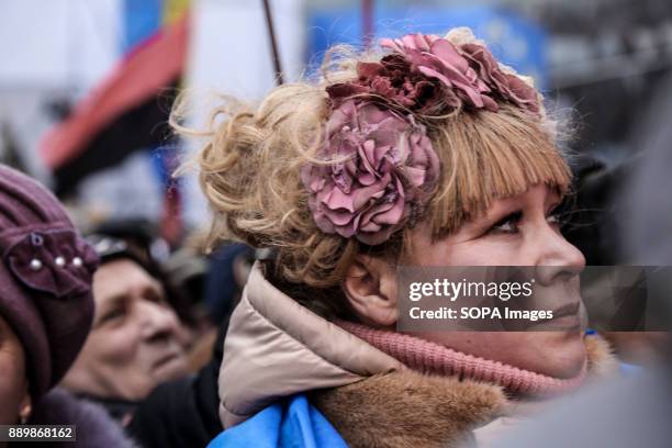 Woman in traditional Ukrainian dress stands with other supporters of Mikheil Saakashvili at a rally held at Maidan calling for the impeachment of...
