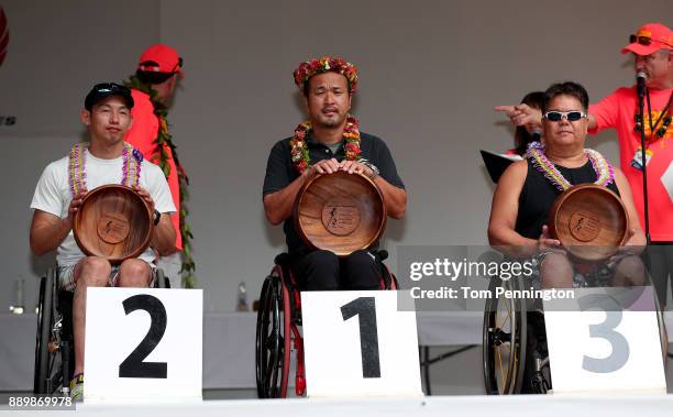 Ken Sato in second place, Masazumi Soejima in first place and John Greer in third place during the awards ceremony for the Men's Wheel Chair Division...