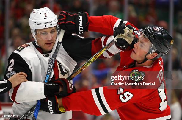 Jonathan Toews of the Chicago Blackhawks tangles with Luke Schenn of the Arizona Coyotes at the United Center on December 10, 2017 in Chicago,...