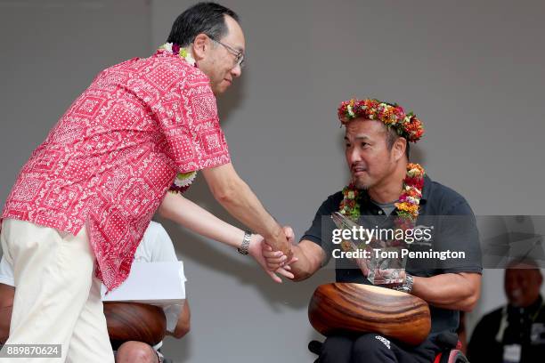 Wheelchair participant Masazumi Soejima receives an award after winning the Men's Wheelchair division during the Honolulu Marathon 2017 on December...