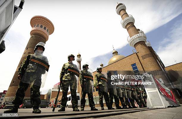 Chinese paramilitary police guard the outside of the Grand Bazaar in the Uighur area in the city of Urumqi in China's Xinjiang region on July 12,...