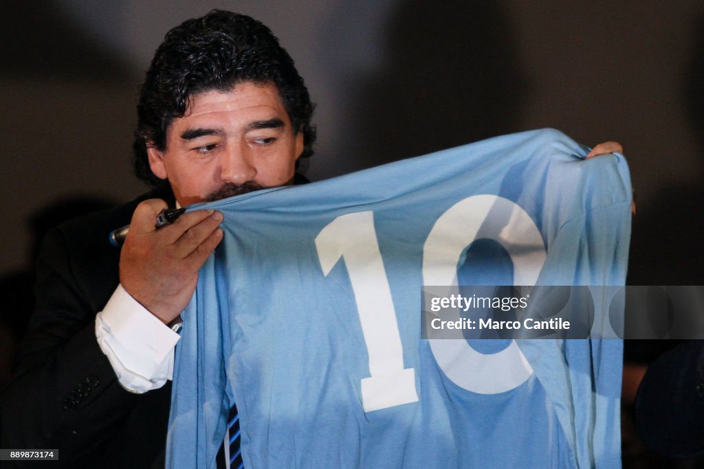 The famous football player Diego Armando Maradona, kisses...