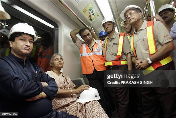In this picture taken June 9 Delhi Metro Rail Corporation Managing Director E. Shreedharan briefs Delhi Chief Ministrer Shiela Dikshit and Delhi's...