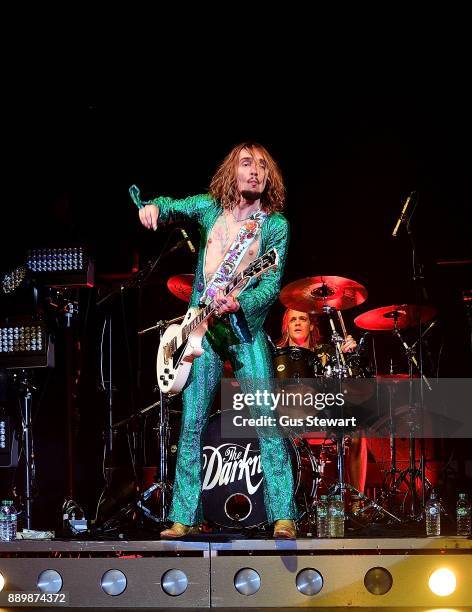 Justin Hawkins and Rufus Taylor of The Darkness perform on stage at the Eventim Apollo on December 10, 2017 in London, England.