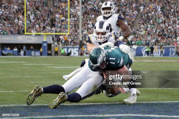 Carson Wentz of the Philadelphia Eagles is hit by Mark Barron of the Los Angeles Rams during the third quarter of the game. Wentz was later escorted...