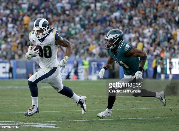 Running back Todd Gurley of the Los Angeles Rams carries the ball while being pursued by cornerback Patrick Robinson of the Philadelphia Eagles in...