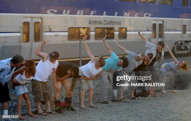 Local residents of Laguna Niguel expose their buttocks during the 30th annual "Mooning of the trains" event along a stretch of railroad track in...