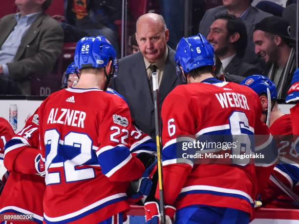 Head coach of the Montreal Canadiens Claude Julien regroups his players against the Calgary Flames during the NHL game at the Bell Centre on December...