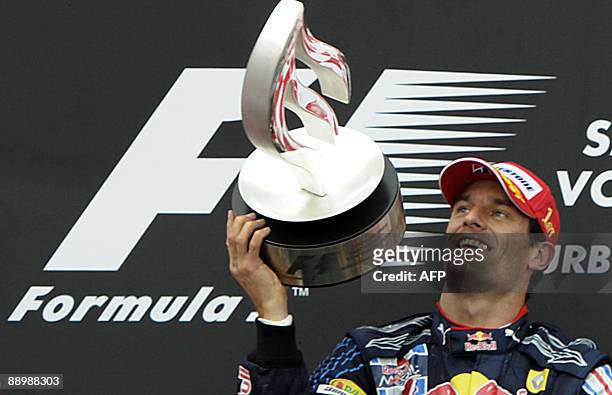 Red Bull's Australian driver Mark Webber celebrates on the podium of the Nurburgring racetrack on July 12, 2009 in Nurburg, after the German Formula...