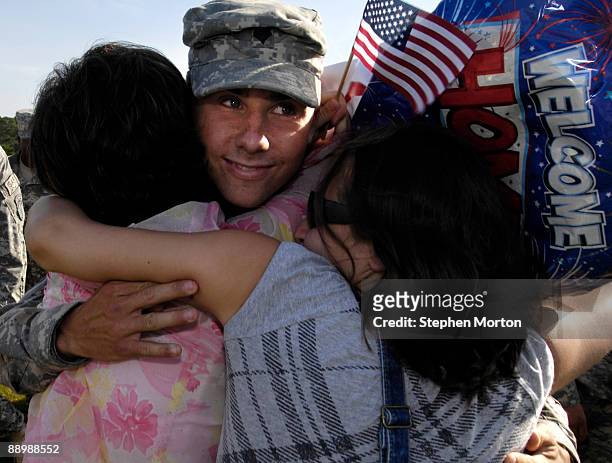 Army SPC Kirk Jones is welcomed home by his mother Georgia Jones and sister Emily Jones during a homecoming ceremony for more than 130 Soldiers with...