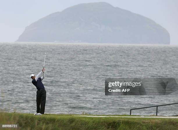 Tiger Woods tees off of the 9th tee box with the island of Ailsa Craig behind on the Ailsa Course at Turnberry, Scotland July 12, 2009. The 2009...