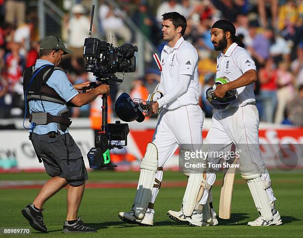 James Anderson and Monty Panesar of England walk off after securing the draw during day five of the npower 1st Ashes Test Match between England and...