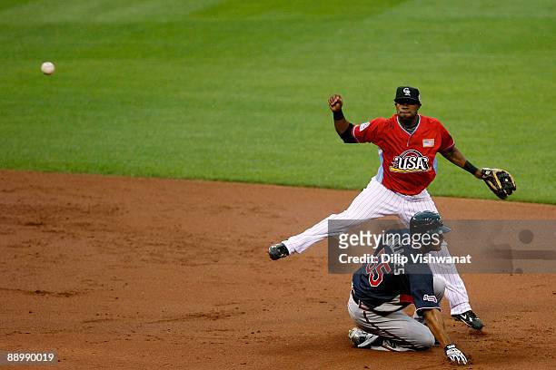 Futures All-Star Eric Young of the Colorado Rockies turns a doubleplay over World Futures All-Star Luis Durango of the San Diego Padres during the...