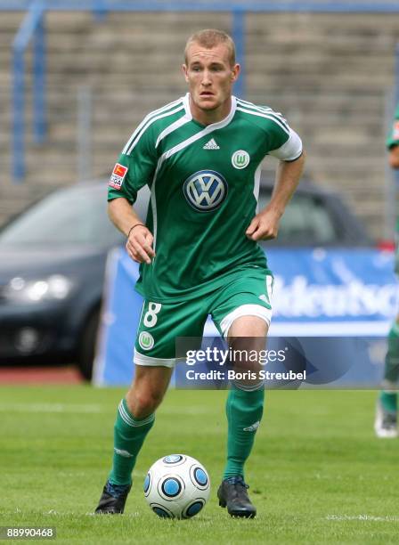 Thomas Kahlenberg of VfL Wolfsburg runs with the ball during the pre-season friendly match between Dessau and VfL Wolfsburg at the Paul-Greifzu...