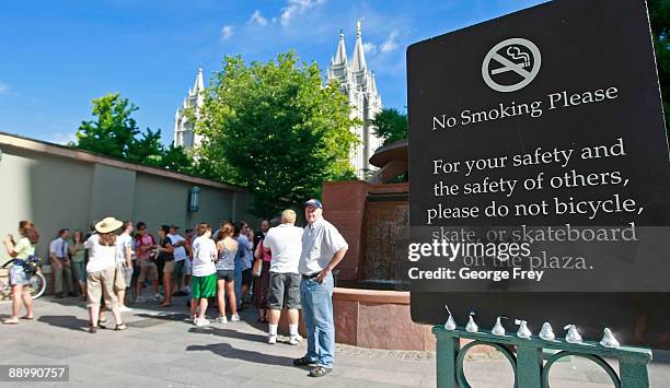 Chocolate Kisses are lined up at the bottom of a sign at the entrance of the Mormon owned Main Street Plaza as protesters gather in the background...