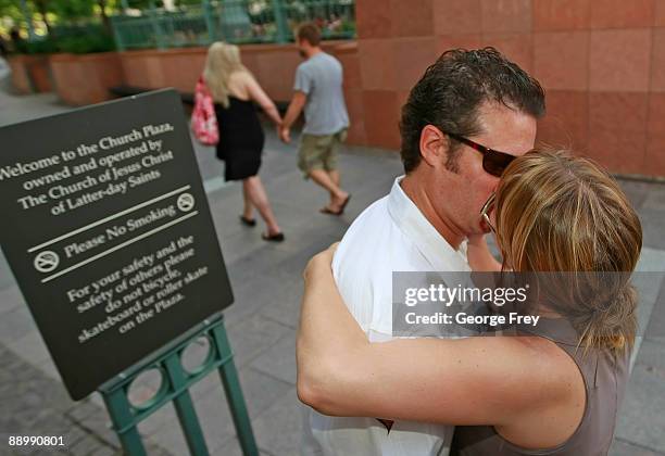 Two protesters kiss as two more enter the Mormon owned Main Street Plaza July 12, 2009 in Salt Lake City, Utah. The protesters defied church security...