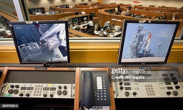 Monitors in Firing Room Four of the Launch Control Center show launch pad 39a with the space shuttle Endeavour and the inspection team at NASA's...