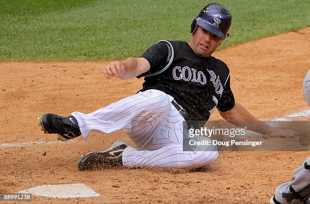 Seth Smith of the Colorado Rockies slides home with the winning run on a game winning RBI single by Brad Hawpe off of Luis Valdez of the Atlanta...