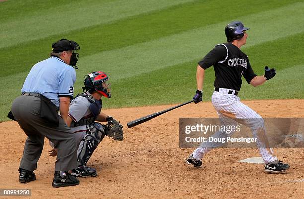 Brad Hawpe of the Colorado Rockies watches his game winning RBI single off of Luis Valdez of the Atlanta Braves as catcher David Ross of the Braves...