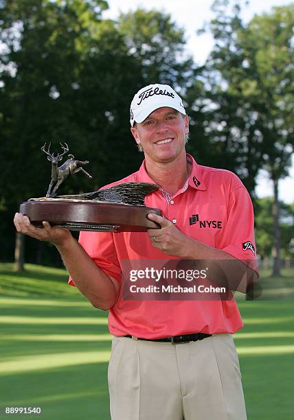 Steve Stricker of the USA holds the trophy after winning the John Deere Classic at TPC Deere Run held on July 12, 2009 in Silvis, Illinois.