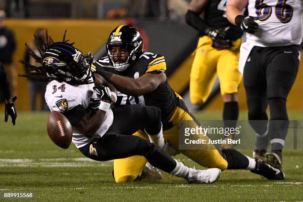 Alex Collins of the Baltimore Ravens fumbles the ball after being hit by Javon Hargrave of the Pittsburgh Steelers in the first quarter during the...