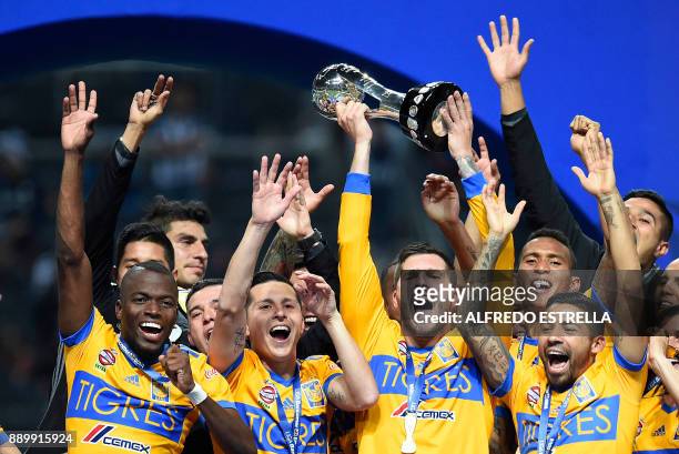 Tigres players celebrate their victory as they rise the trophy, after winning the Mexican Apertura 2017 football tournament final match against...
