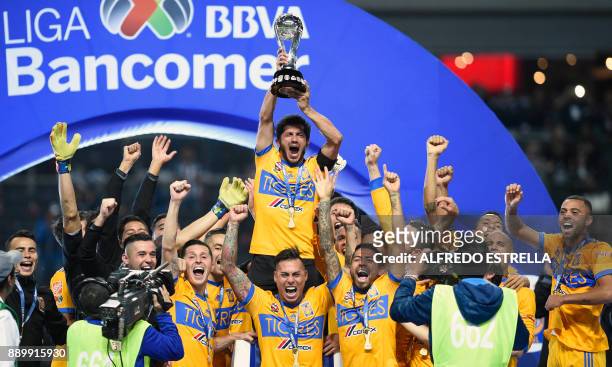 Tigres players celebrate their victory as they rise the trophy, after winning the Mexican Apertura 2017 football tournament final match against...