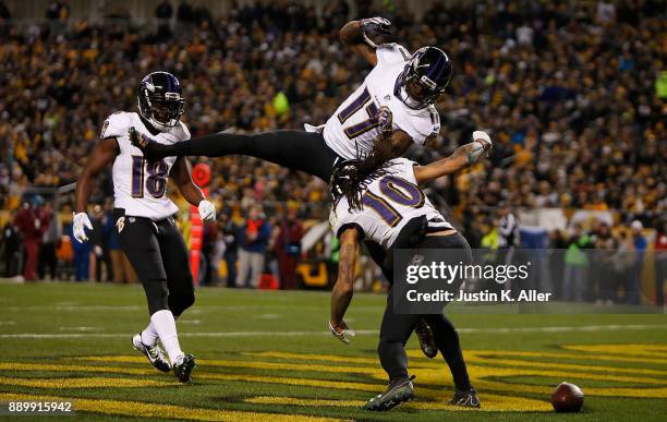 Chris Moore of the Baltimore Ravens celebrates with Mike Wallace after a 30 yard touchdown reception in the second quarter during the game against...