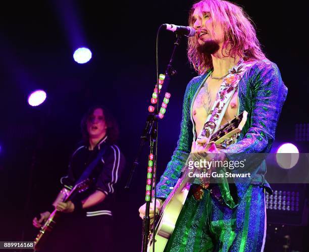 Dan Hawkins and Justin Hawkins of The Darkness perform on stage at the Eventim Apollo on December 10, 2017 in London, England.