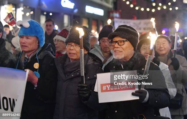 Atomic bomb survivors join others in a parade in Oslo after the Nobel Peace Prize award ceremony on Dec. 10, 2017. ==Kyodo