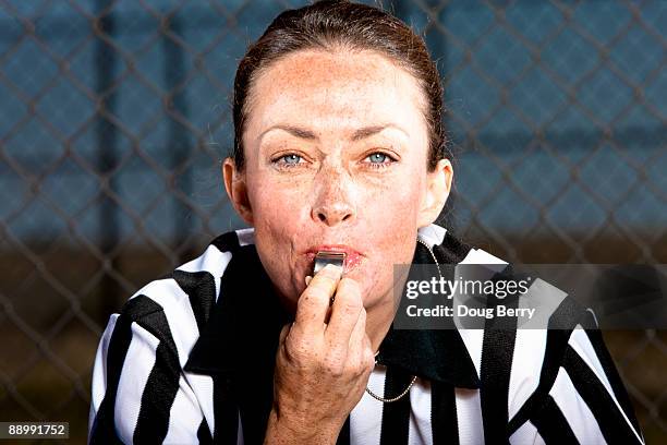 female referee with whistle and stripped shirt - female umpire stockfoto's en -beelden