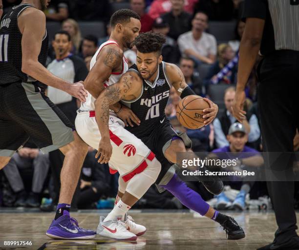 Sacramento Kings guard Frank Mason III is defended by Toronto Raptors forward Norman Powell on Sunday, Dec. 10, 2017 at the Golden 1 Center in...