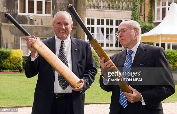 Michael Ball, Chairman of the Bradman Foundation, and former Prime Minister of Australia John Howard AC, pose with two 'Bradman Cricket Bats' at the...