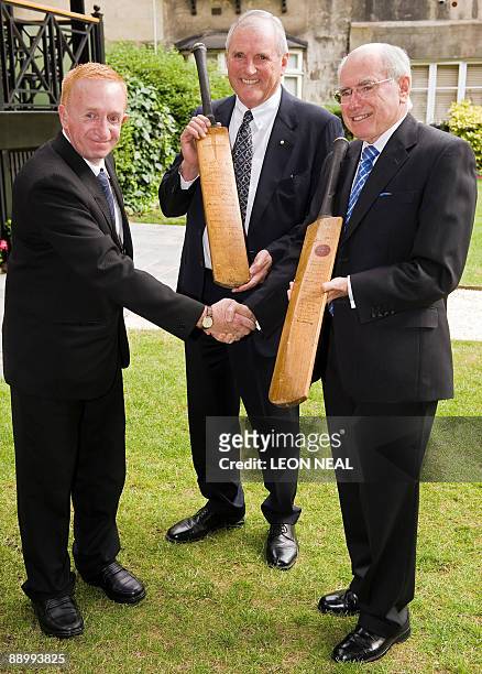 Michael Ball, Chairman of the Bradman Foundation , Eugene Withers and former Prime Minister of Australia John Howard AC pose with two 'Bradman...