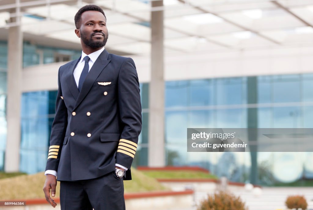 Airline pilot in airport terminal