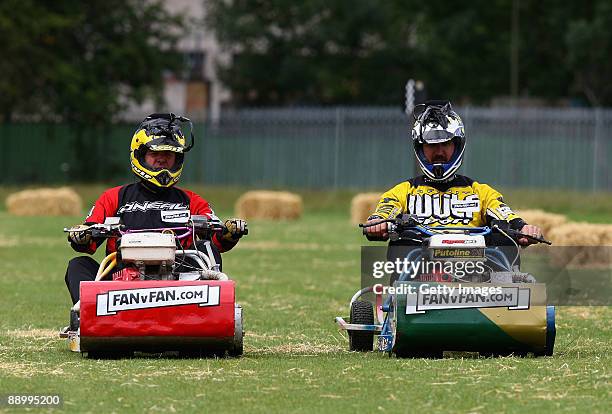 Ashes legend Phil 'Tuffers' Tufnell of England races Jason 'Dizzy' Gillespie of Australia during the Betfair Lawnmower Challenge at Cricklewood...